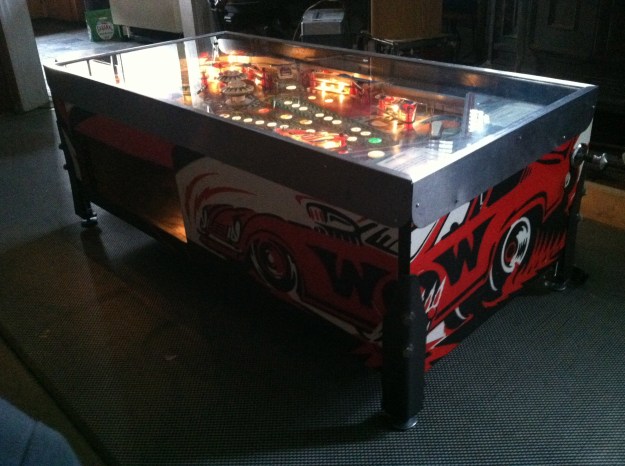 Bally Ground Shaker pinball main console redesigned into a coffee table with magazine storage. 44”L x 22 1/2” W x 17” H