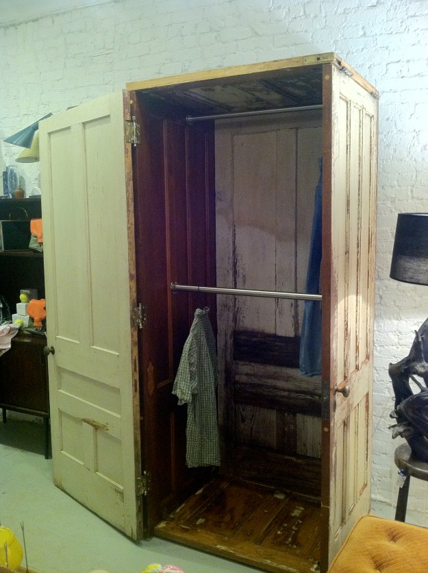 Armoire with single door entry, made out of 5 vintage doors, 18 vintage hinges, and a double hanger that can accommodate long and short clothes. 83"h x 34"w x 30"deep.