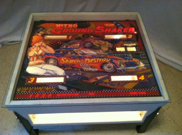 Bally Ground Shaker pinball scoreboard console redesigned into a coffee table with magazine storage. 31”L x 28 1/2“W x 17” H