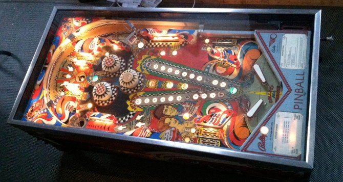 Bally Ground Shaker pinball main console redesigned into a coffee table with magazine storage. 44”L x 22 1/2” W x 17” H